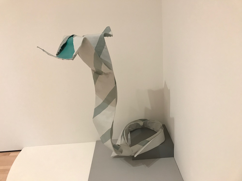 This is a photo of a sculpture of a dress tie that is shaped like a snake