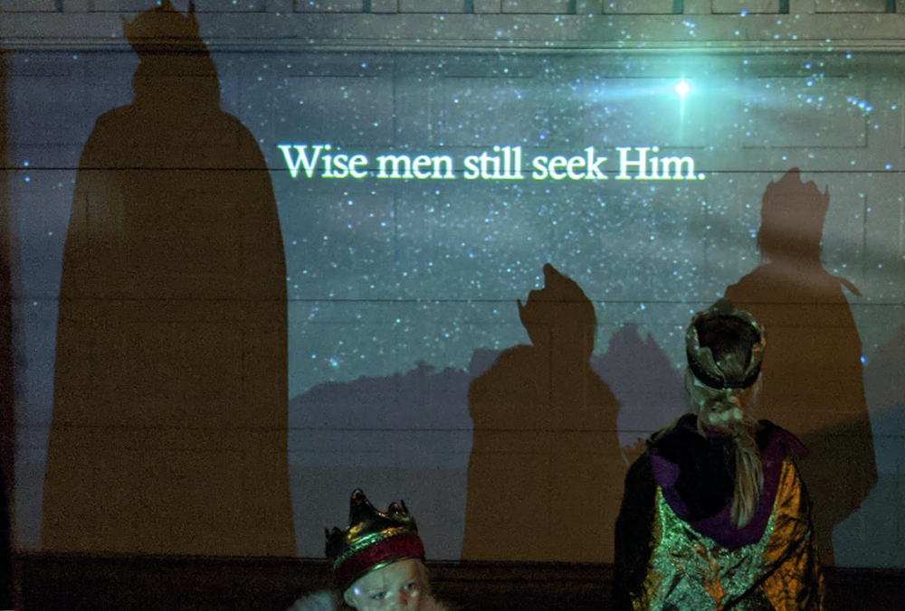 Wise men still seek him projected on garage with shadows of wisemen on it