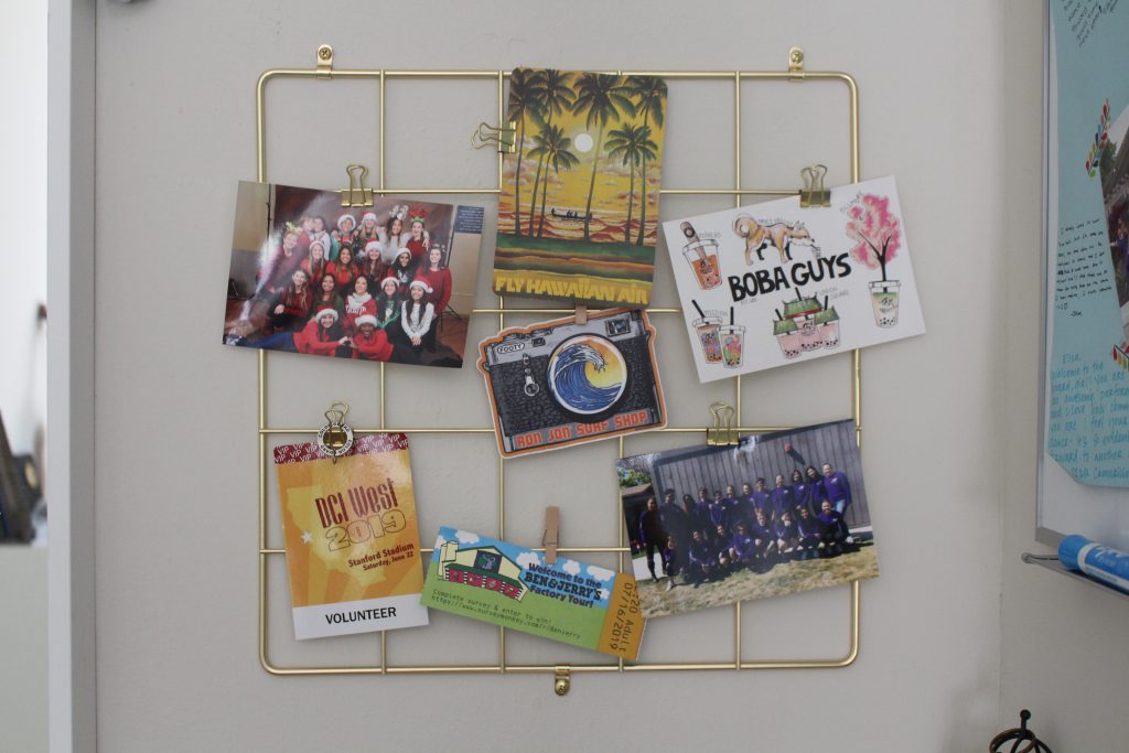 Photo of a "self-portrait". The photo shows a grid mounted on a wall with ticket stubs, postcards and photos hanging on it.