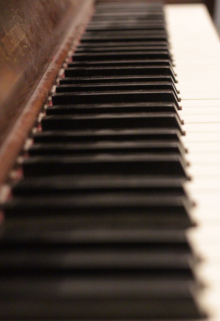 Photo of Leading Lines. Photo shows a Grand Piano's keys in order to show infinity. 