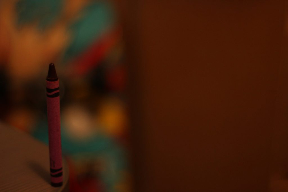 Photo using the rule of thirds to show motion. The photo shows a crayon on the edge of a desk.