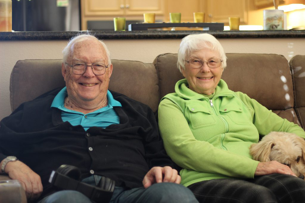a smiling elderly married couple