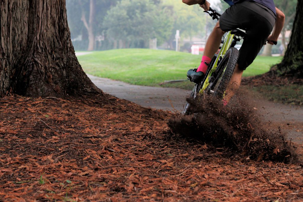 A picture of a person drifting in the dirt with the dirt flying up off the ground.