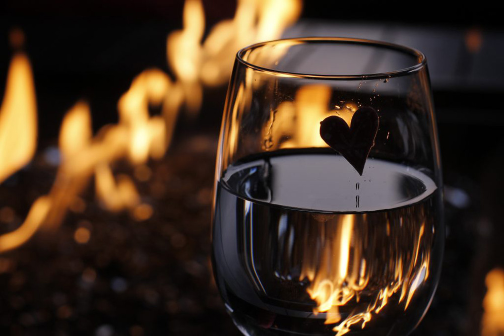 Heart in water glass with fire