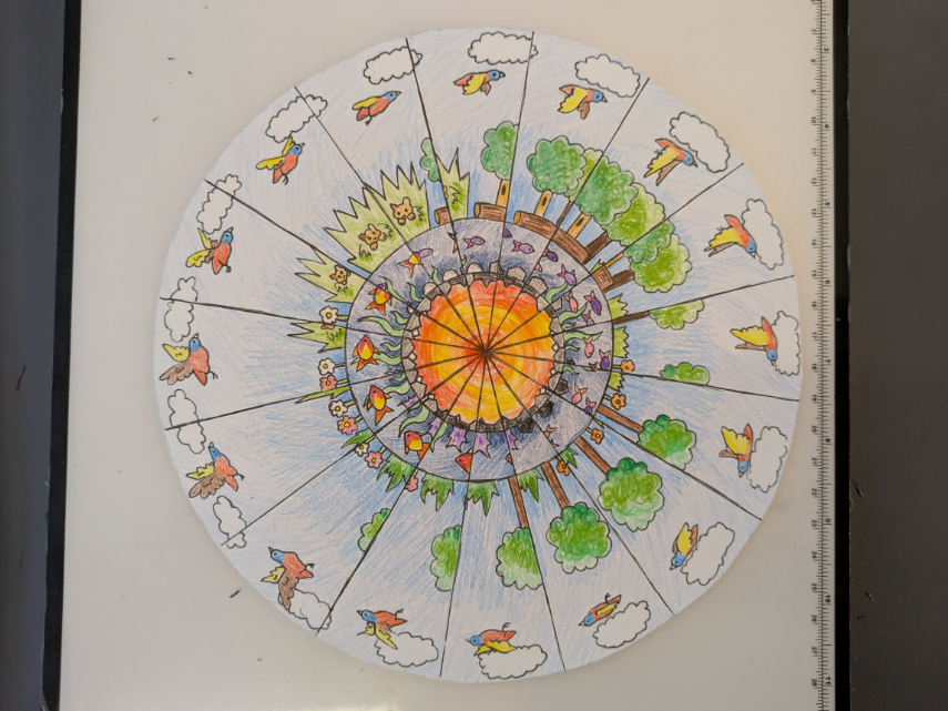 a phenakistoscope wheel which contains an animation of a bird flying, a forest, and fish swimming