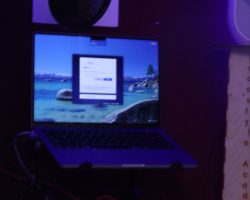 The Iso Booth A picture of the recording booth with a mic, laptop, and speakers