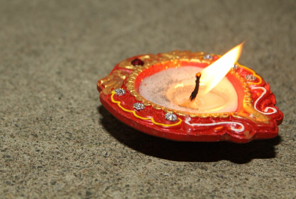 red diya with painted details