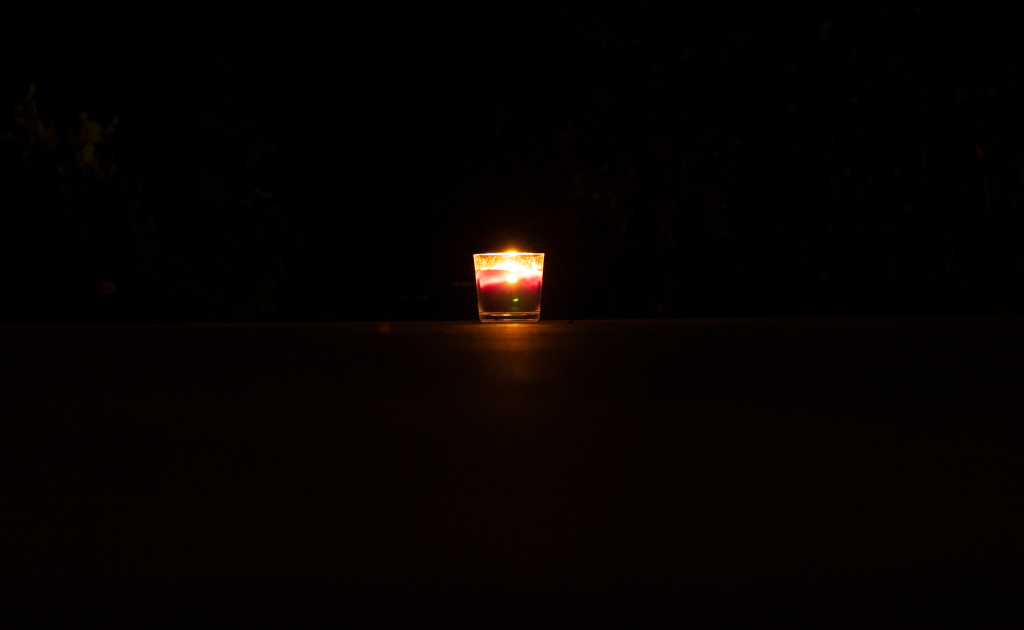A candle surrounded by darkness.