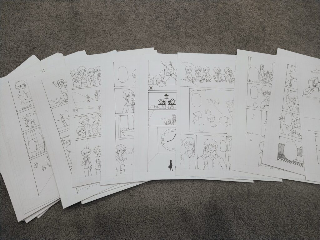 A photo of a number of pages laid out - on them, comics are drawn. 