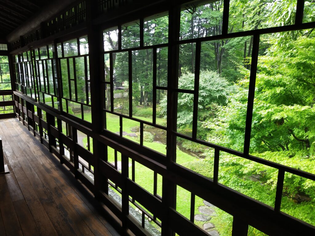 A yard, seen from the inside of a traditional Japanese home. 