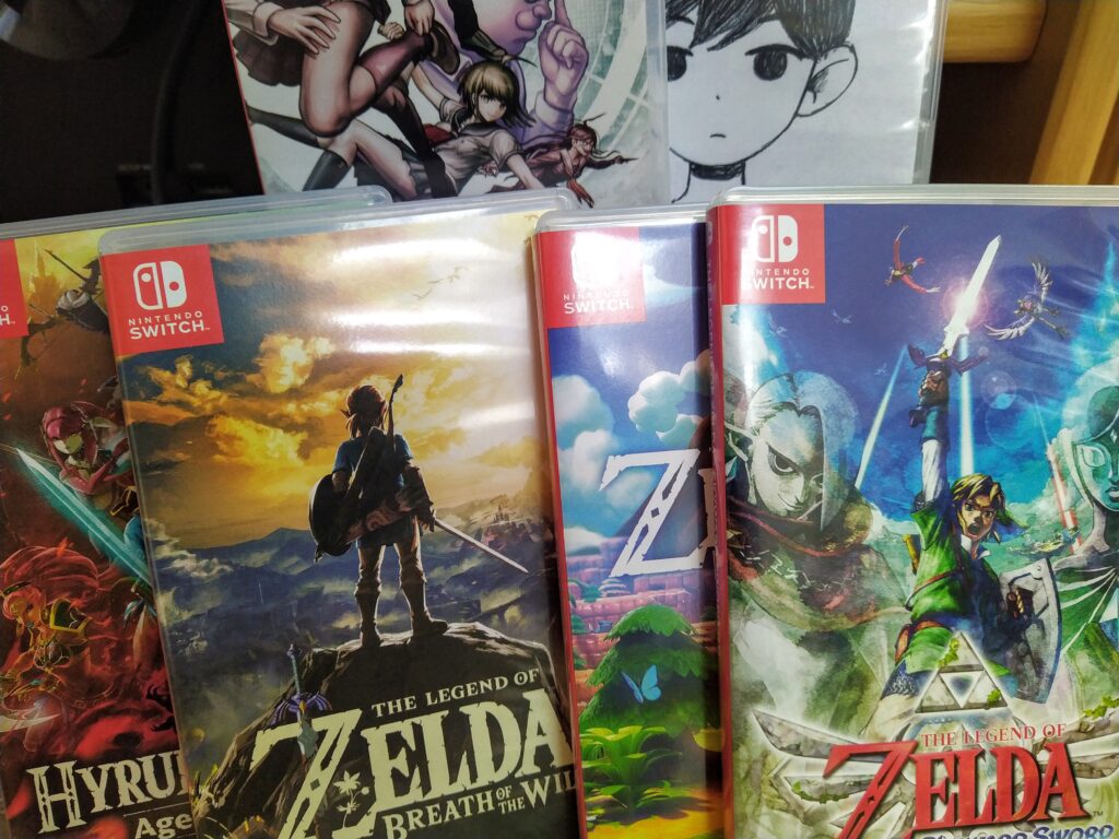 A bunch of games that can be played on the Nintendo Switch. Danganronpa, Omori, Skyward Sword, Link's Awakening, Breath of the Wild, and Hyrule Warriors Age of Calamity. 