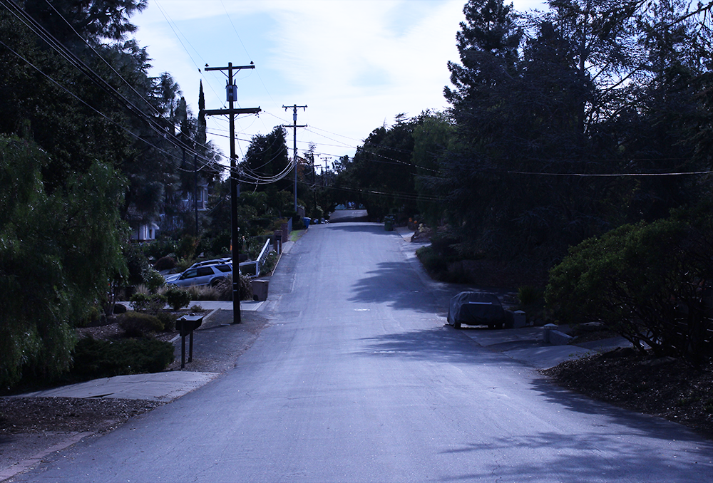 a view from standing in the middle of a hilly street