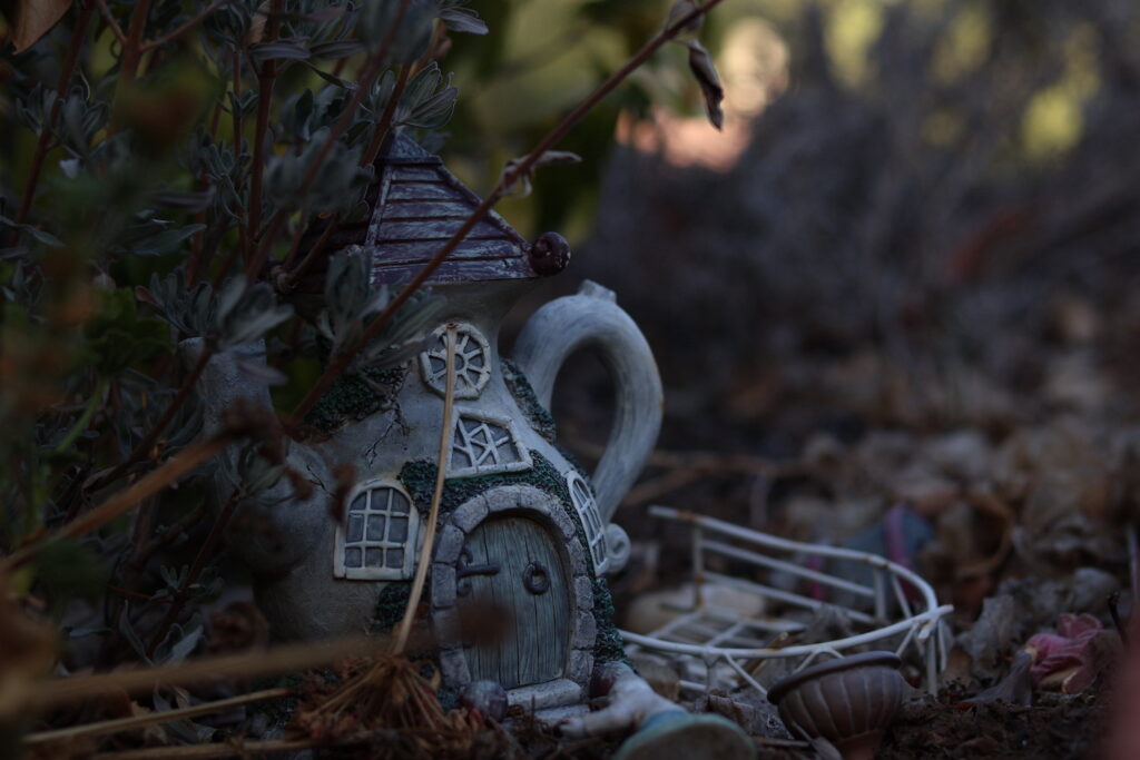 A close up of a teapot house in a fairy garden
