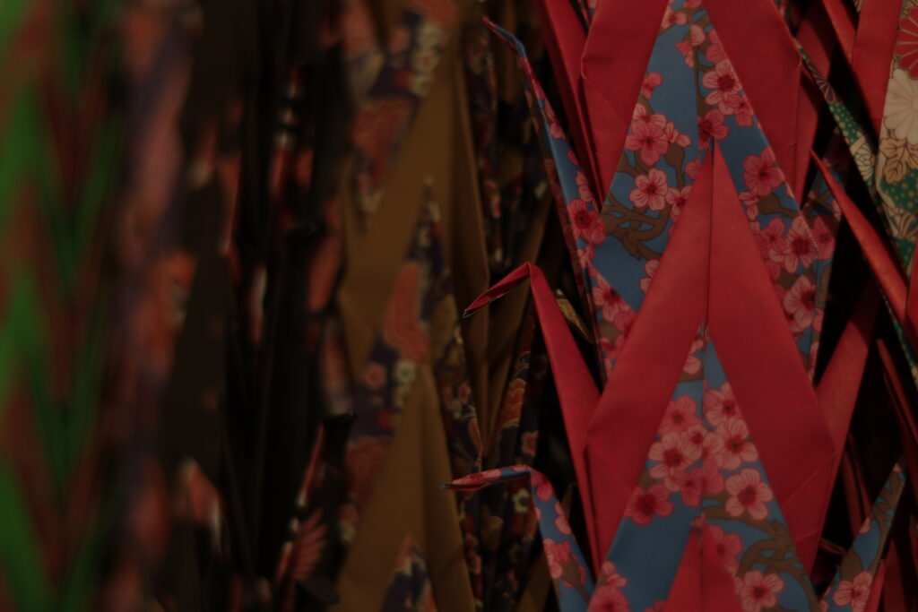 Close up of a bundle of different colored and patterned paper cranes