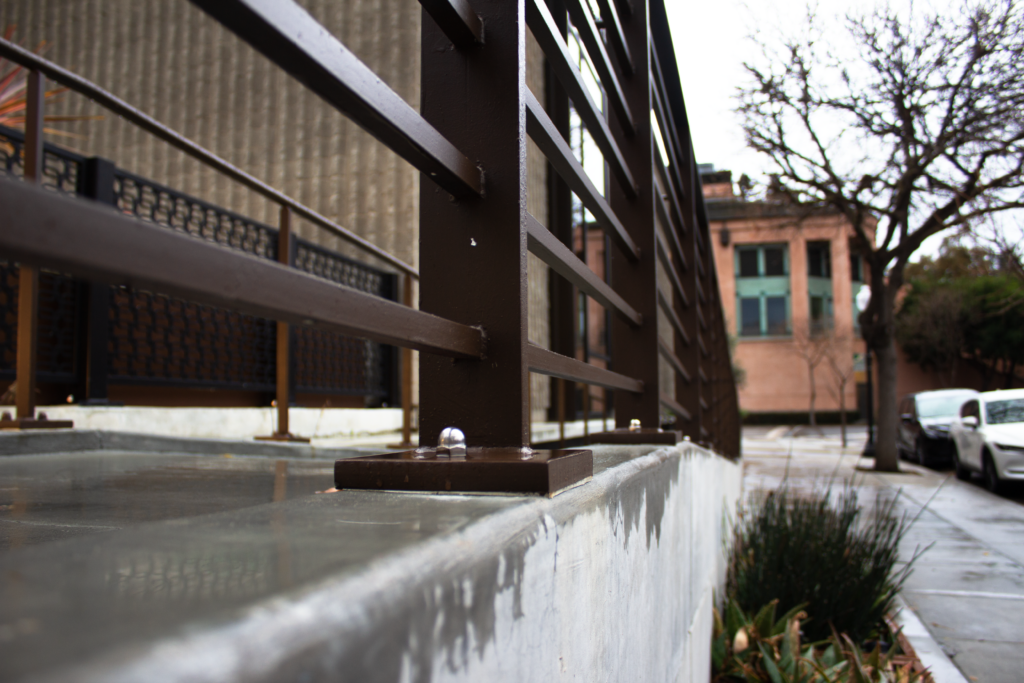 A railing leading into the center of the photo on a rainy day