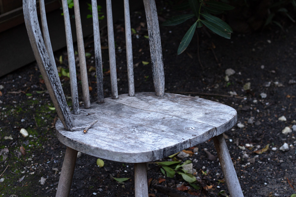 A close up of an old weathered down chair