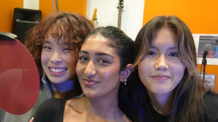 Saumya, Karen and Athena smiling side by side