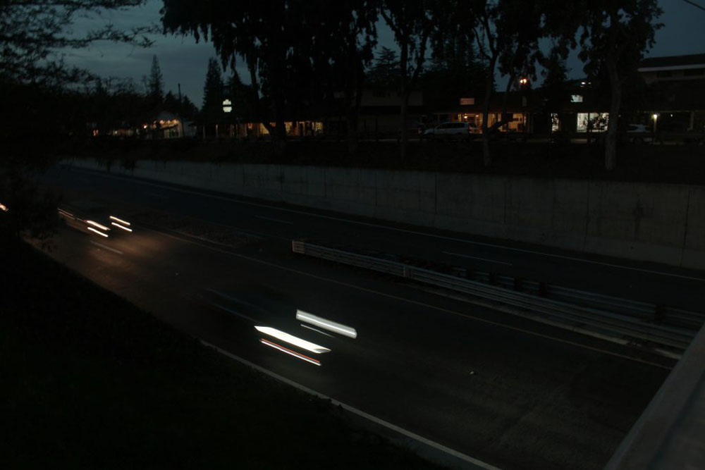 Two cars on a expressway with dragged out headlights
