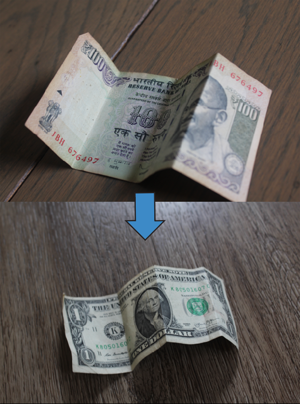 The rupee with an arrow pointing down to a dollar.
