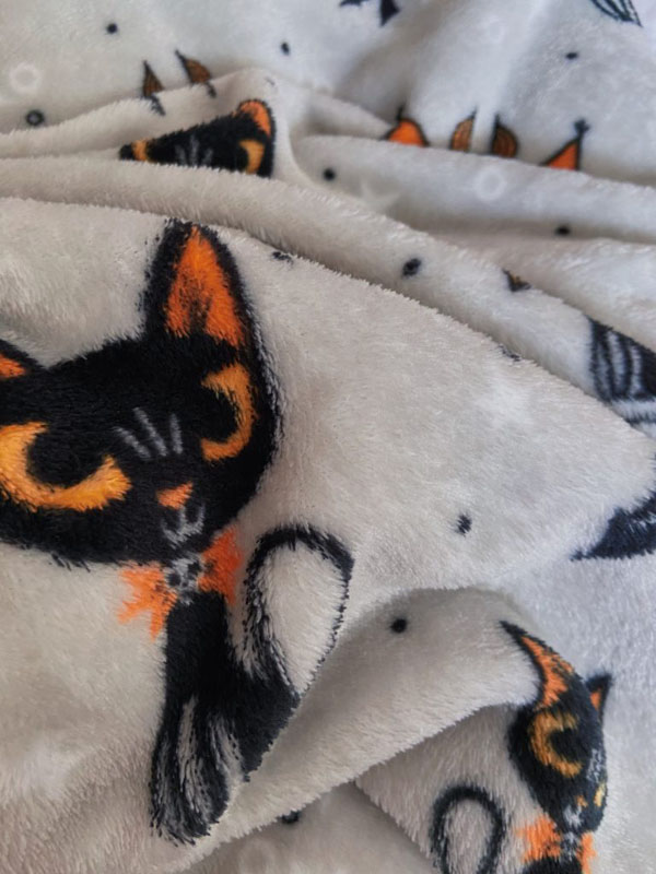 Halloween themed blanket with grey background and orange and black cats and bats