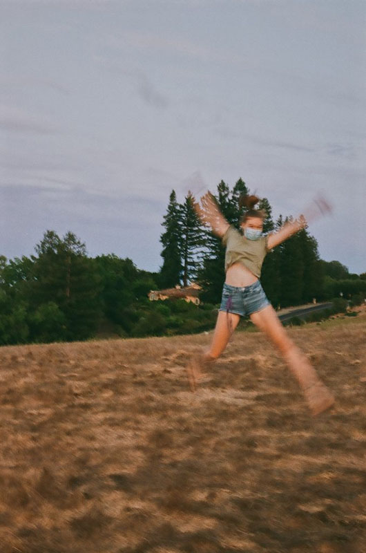 Photo of a girl starfish jumping on a hill
