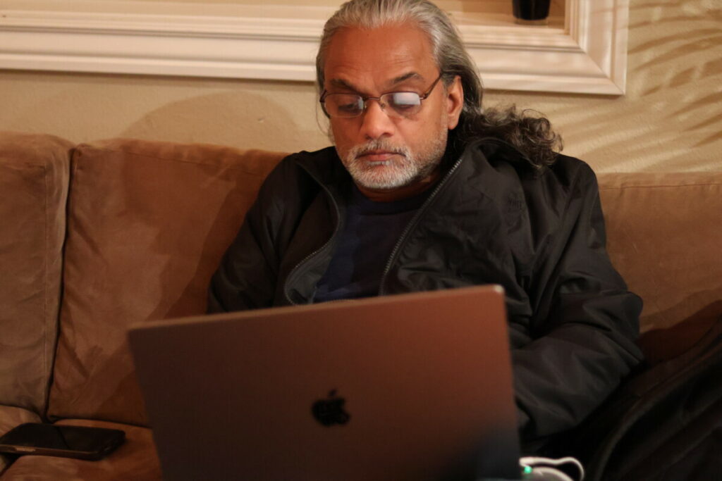 pic of man in glasses on his laptop