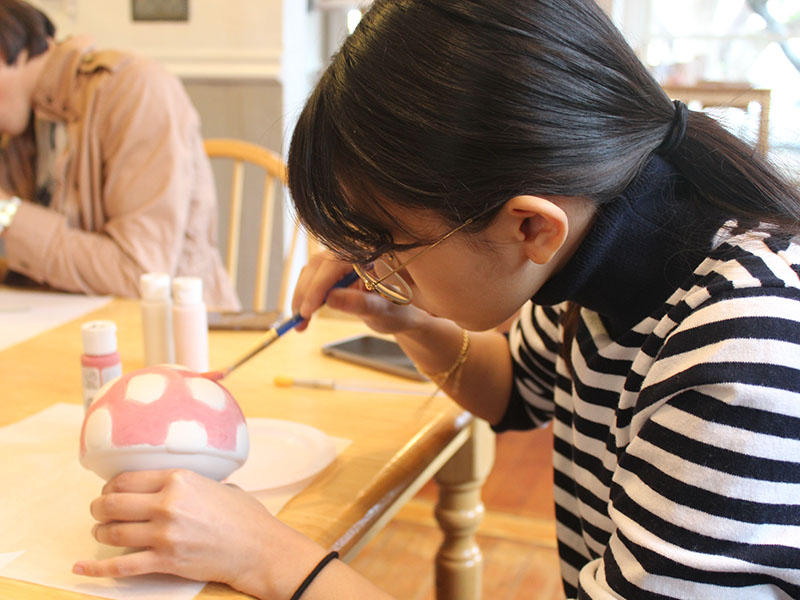 Andrea painting her mushroom