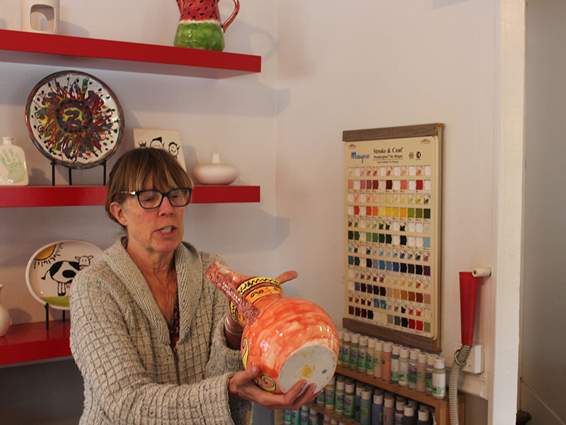 Lisa explaining to me and my friends how to paint the pottery