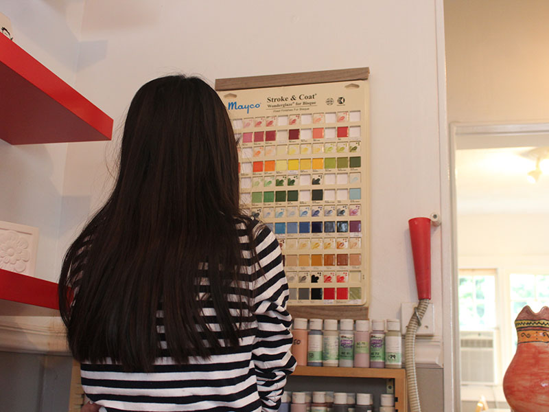 My friend looking at which color she wants to paint with 