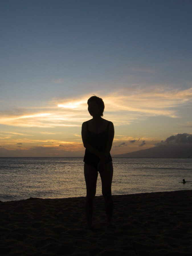 silhouette of woman in front of sunset