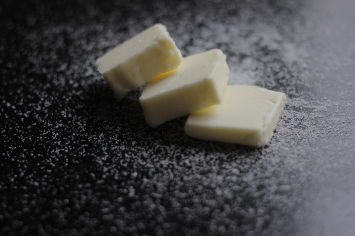 Butter and sugar on black table 