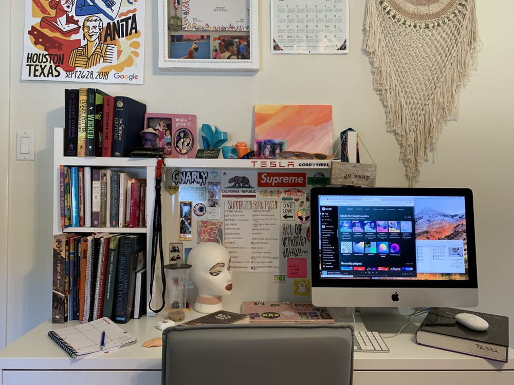 Photo of a self-portrait without showing one's face. The photo demonstrates a cluttered desk.