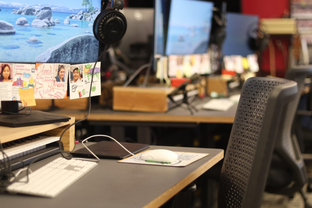 An image of Freestyle Academy's Digital Media room, showing a few black chairs and computers