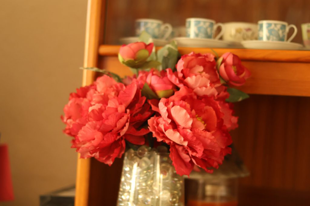 Red flowers in a shiny gray vase