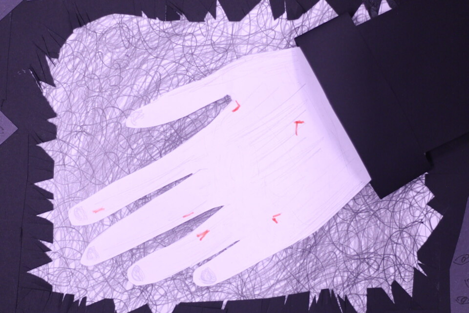 A white hand with specks of red