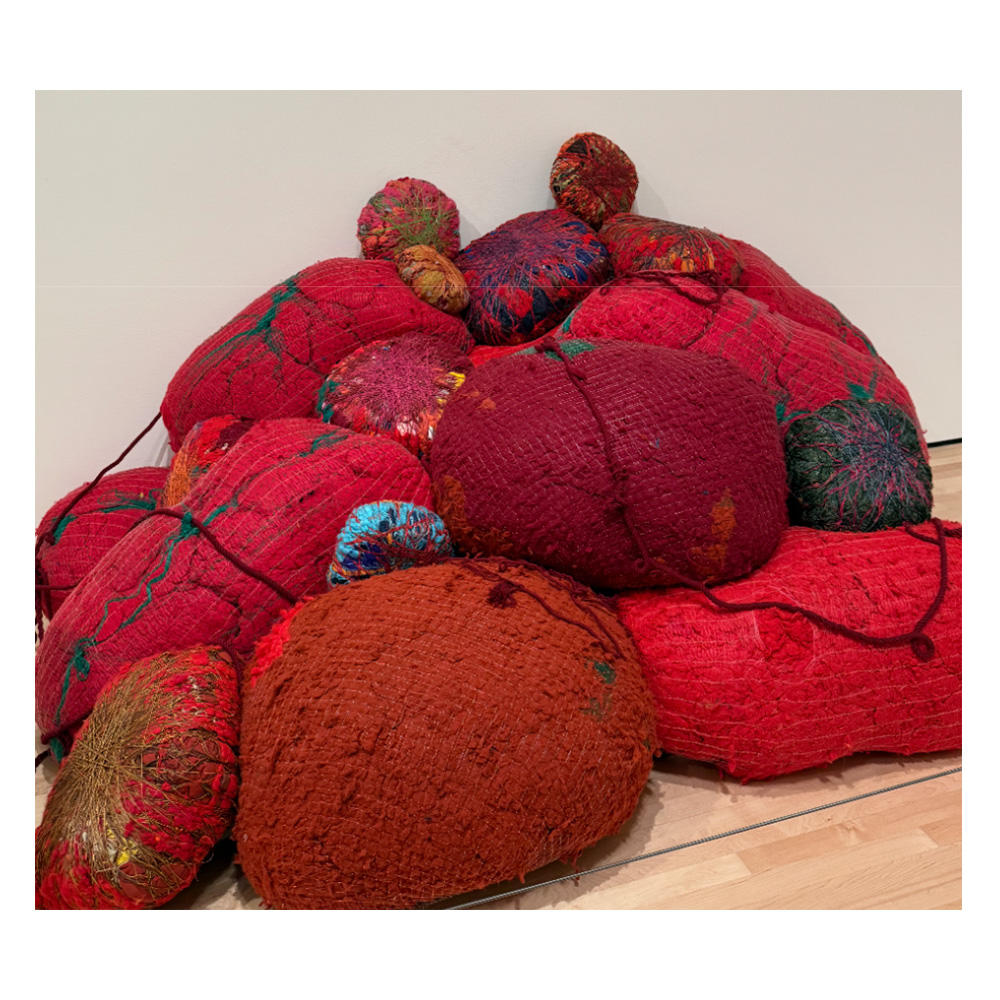 Image of yarn, string, and materials tied up in colorful balls