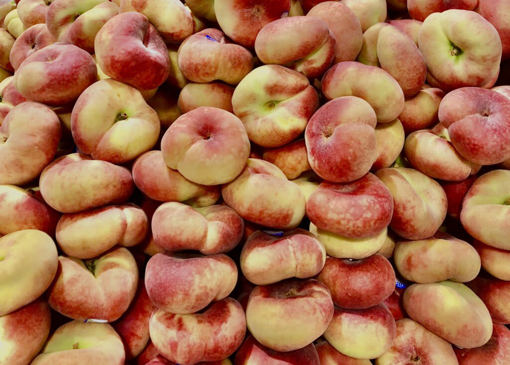 For this week's photo challenge, I was assigned to take a picture inspired by "food". I chose a picture of stacked flat peaches that I took at the farmer's market. 