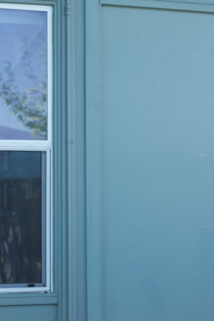 Photo of a blue wall, with a window in the left, exemplifying rule of thirds.