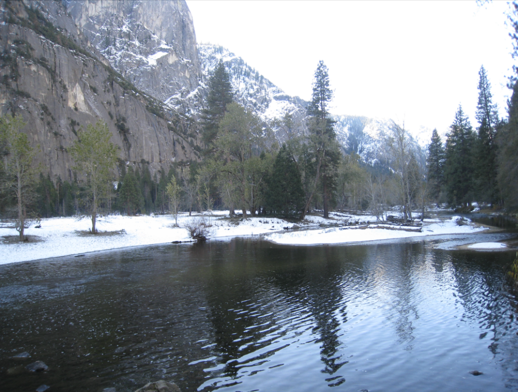 Photo of Yosemite with a large lake and scenery reflected in the water.