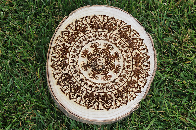 engraved mandala on tree trunk slice
