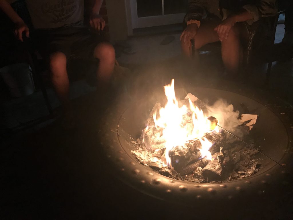This is a picture that uses the rule of thirds and shows motion. In this picture we are roasting marshmallows over a fire place.