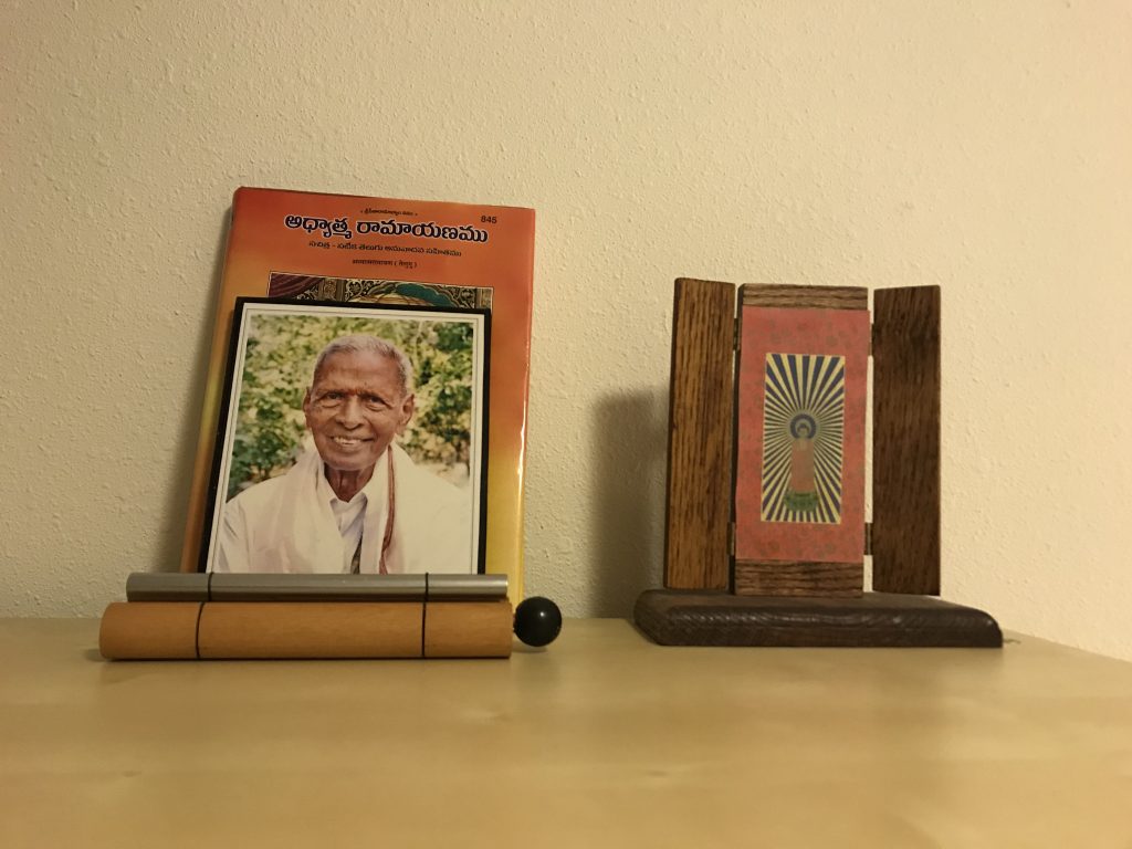 A picture of a Buddhist shrine next to my late grandfathers picture.