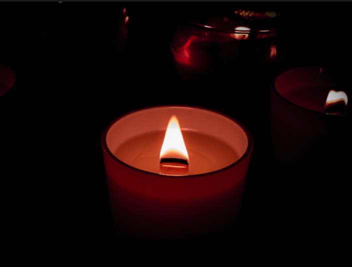 The picture is a burning candle in the foreground with other candles in the background. For the center frame portrait, I took a picture of a burning candle in the foreground with other candles behind it and edited it a little in post to make it seem more isolated.