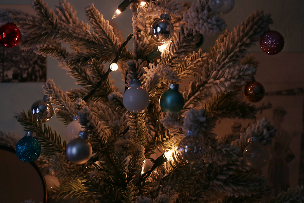 A small Christmas tree with lights and ornaments.