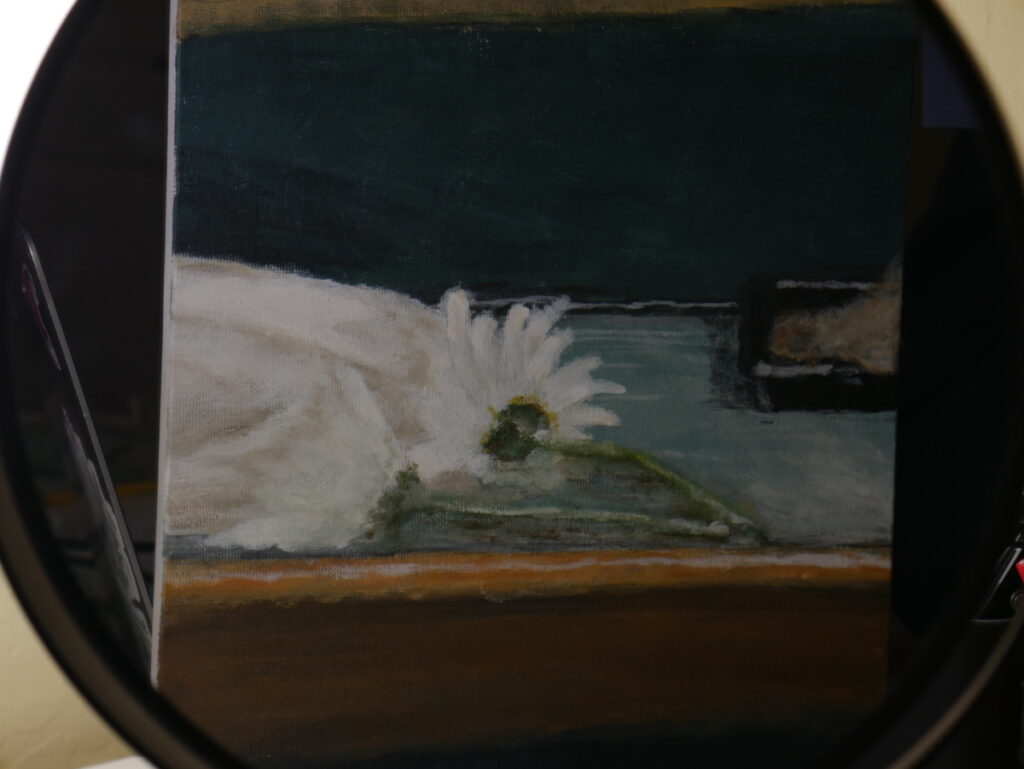 Reflection of a painting in a makeup mirror