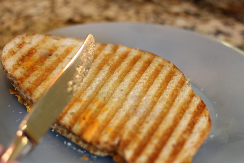 a panini and a butter knife.