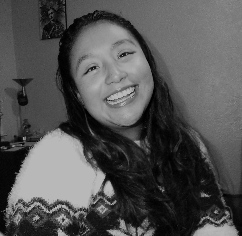 a black and white picture of a person smiling