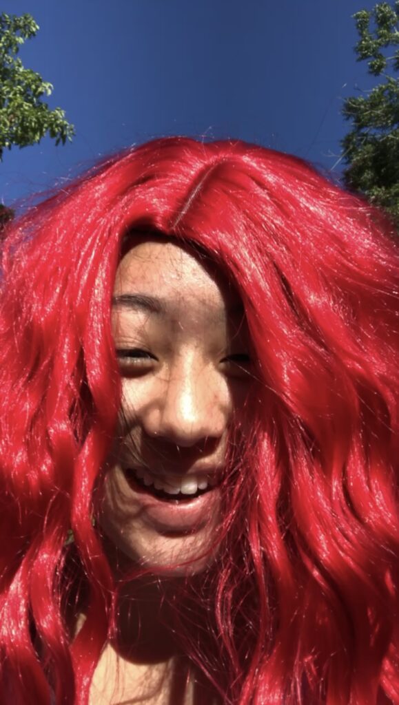 Hannah in a red wig