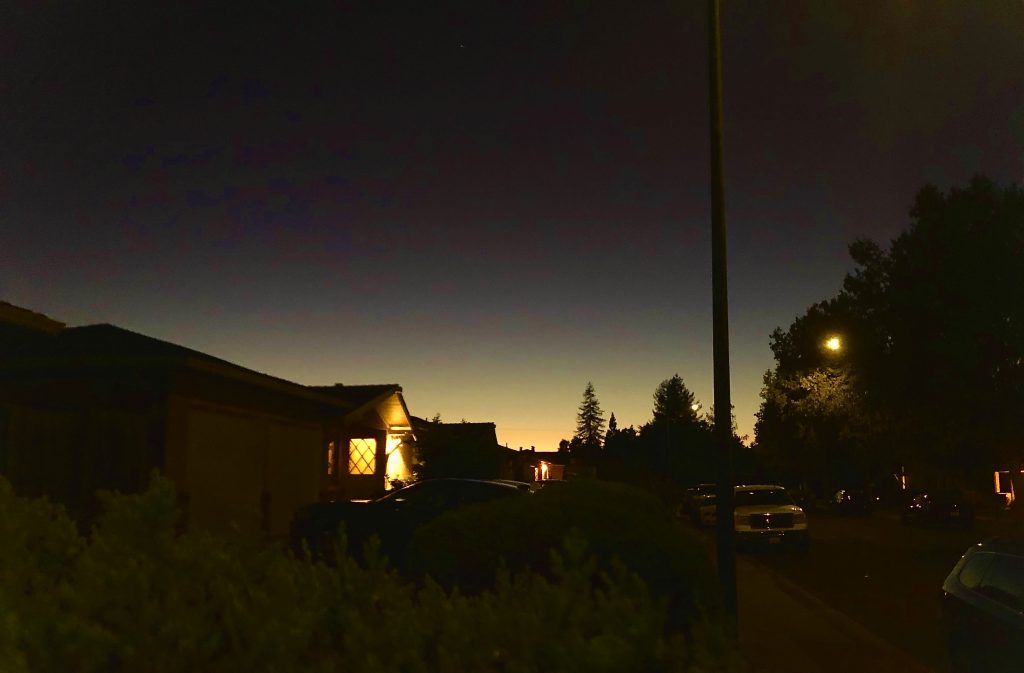 A yellow unset on a suburban neighborhood. 