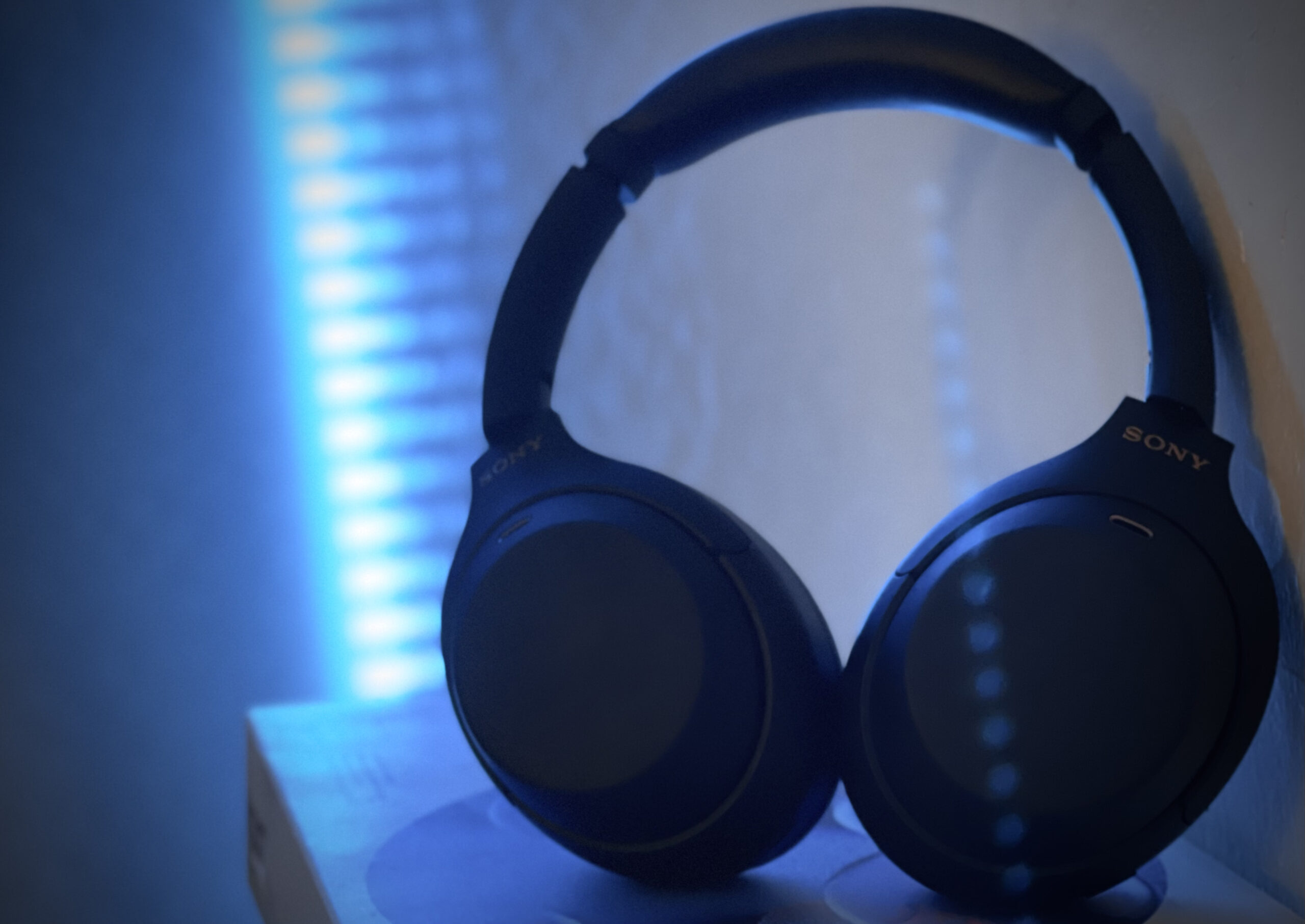 Headphones sitting in front of a glowing background.